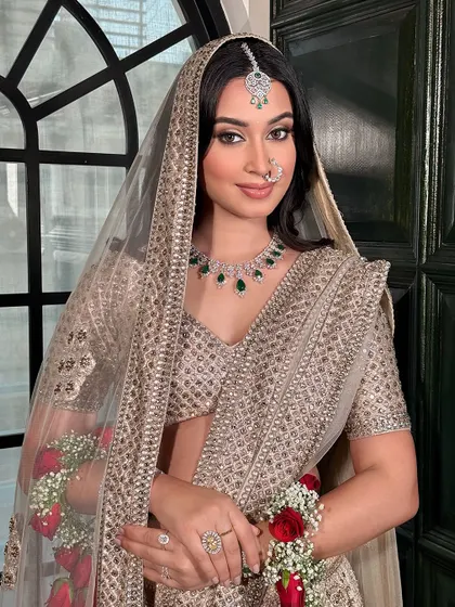 This is the bridal look dreams are made of. I focused on creating a luminous, soft-focus skin finish, beautifully defined eyes, and a classic silhouette with the veil, ensuring a timeless and radiant bridal portrait.