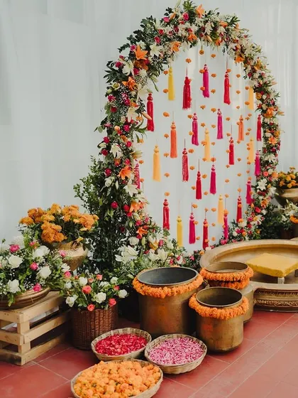 The complete Haldi setup with the floral arch, traditional brass urlis, and pots, creating a stunning focal point for the ritual.
