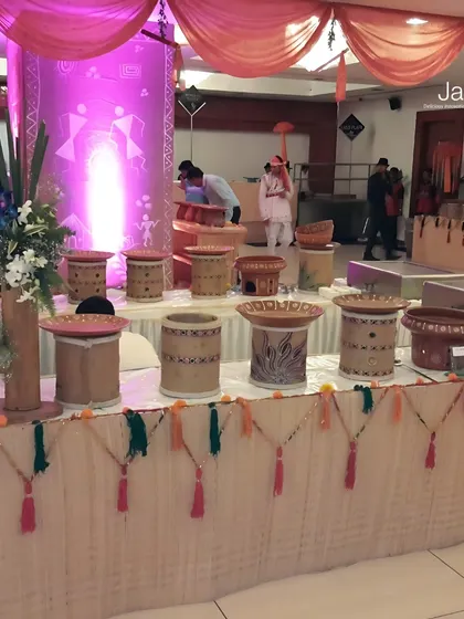 A unique, traditional Indian-themed buffet setup. The use of handcrafted pots, colourful tassels, and ethnic patterns brings a touch of rustic charm to the event.