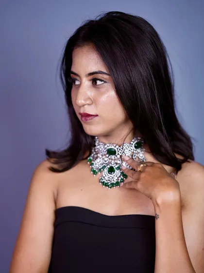 A portrait of the model, her look is bold and modern with this statement Victorian choker.