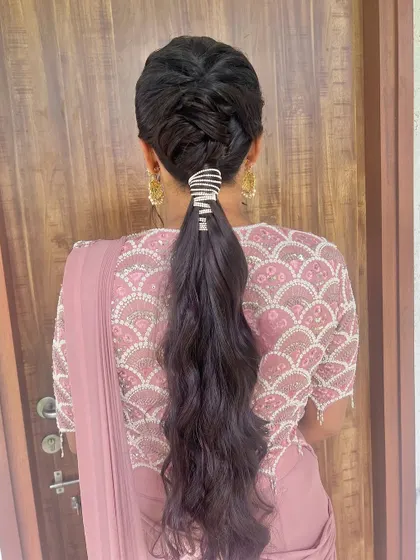 A modern braided ponytail, combining the elegance of a braid with the playfulness of a pony.
