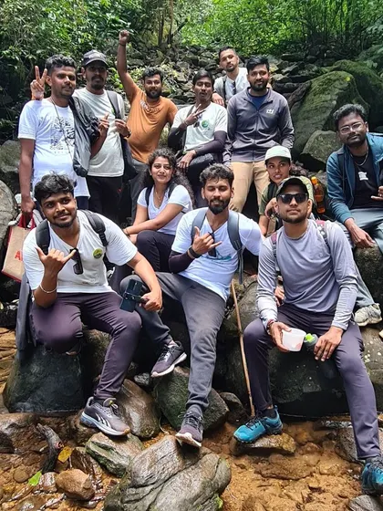 A group takes a break on the rocks along the Kumara Parvatha trail. Staying hydrated and taking rests is key on this long trek.