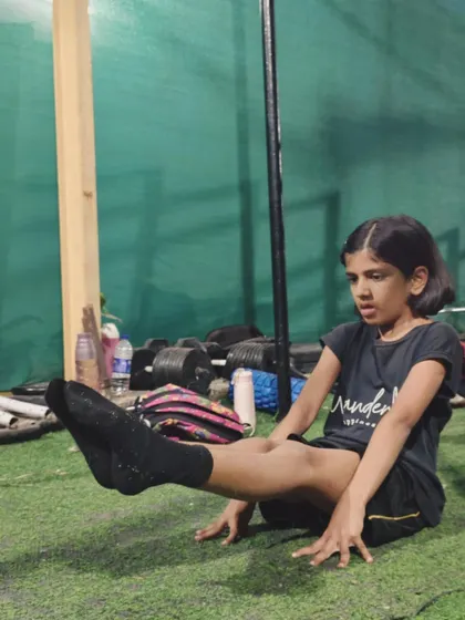 Another young athlete demonstrating a perfect L-sit, showcasing the incredible core strength we build in our kids' program.