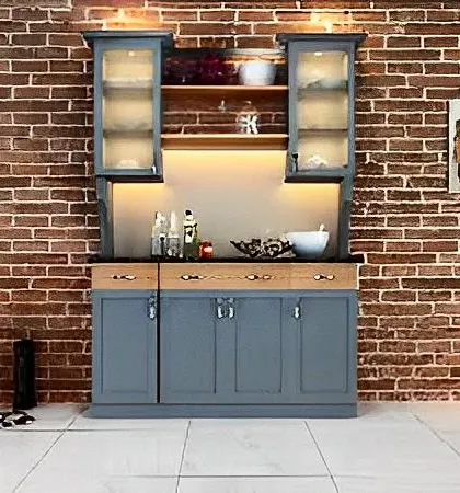A freestanding crockery unit with a rustic-industrial feel. The grey-blue finish contrasts beautifully with the exposed brick wall, and the frosted glass doors add a touch of elegance.