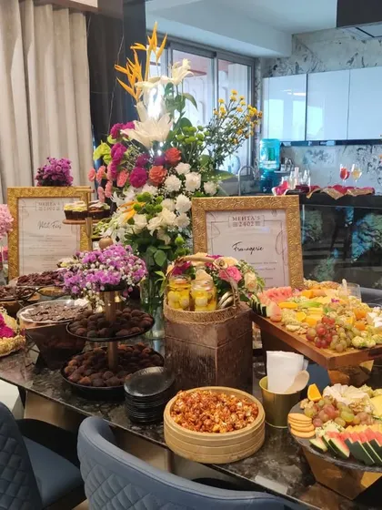 A magnificent grazing table set up for a private housewarming celebration. This spread includes everything from artisanal chocolates and Indian mithais to savoury snacks and fresh fruit, offering something for every palate.
