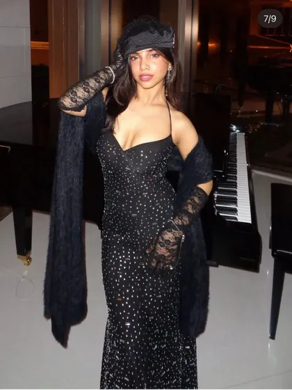 A full look at the vintage-inspired black sequin gown. The faux fur stole and lace gloves complete this glamorous ensemble, all available for rent.