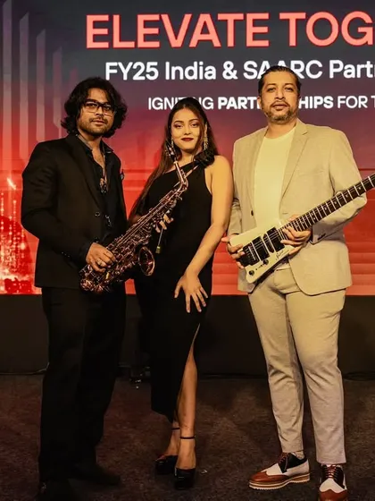 A formal shot of our trio against the event backdrop. We ensure our look and stage presence align perfectly with the professional setting of your event.