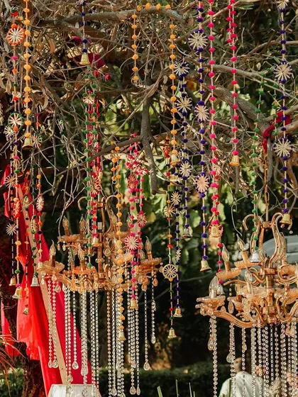 More of the enchanting tree decor, with multiple chandeliers and colourful hangings creating a festive canopy for the celebration below.