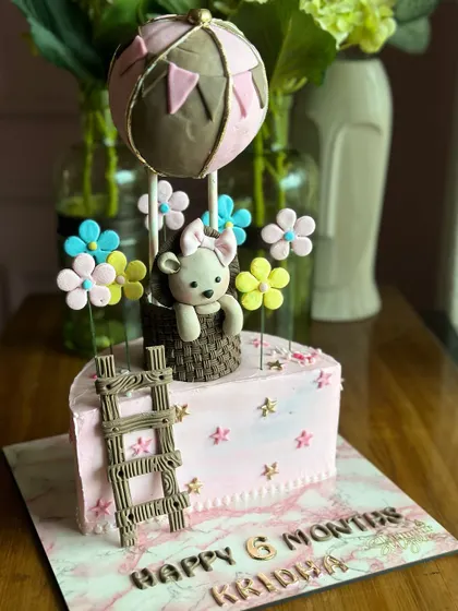 Halfway to one! We love celebrating tiny milestones with cute half-birthday cakes, like this hot air balloon teddy bear cake or the sweet blue animal-themed cake.