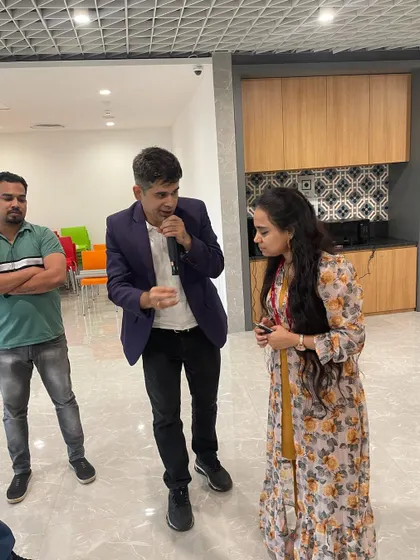 Explaining the rules of a game to a participant at a corporate event.