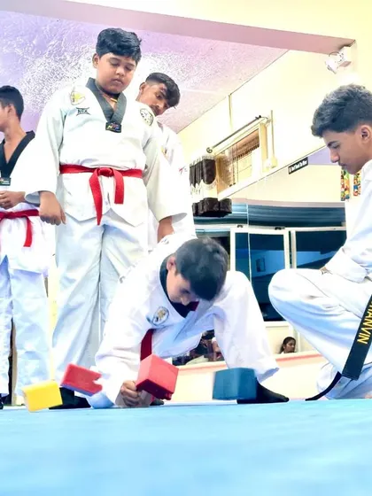 Another student takes on the block-breaking challenge.