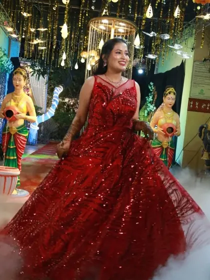 Live your own fairytale moment in this spectacular red sequin ball gown. The dramatic entrance with the smoke effect shows just how magical this dress can make you feel at your engagement or sangeet.