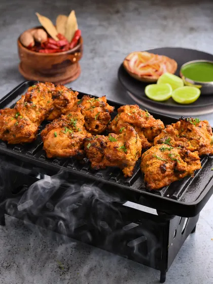 Capturing the smoky essence of Bhatti ka Murgh. We used a mini grill and subtle smoke effects to highlight the charcoal-kissed flavor of the chicken, making it a standout dish for our client.