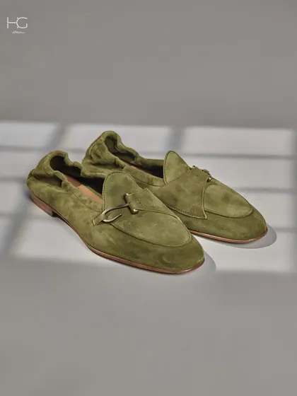 Stepping into the epitome of style and comfort with these olive green suede loafers. The soft material and elegant design make them a luxurious finishing touch.