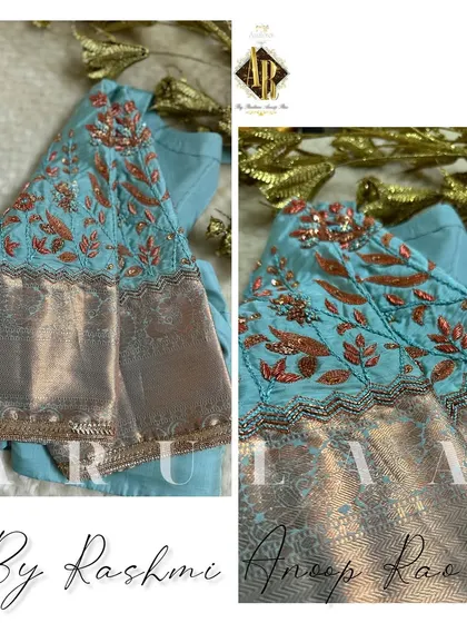 A light blue blouse with contrasting orange and copper thread work. The embroidery is placed just above the silver zari border on the sleeves, creating a unique color combination.