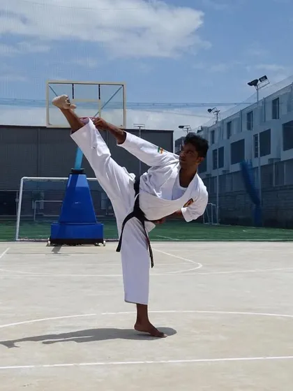 A powerful demonstration of a high kick, capturing the balance and extension we strive for in our training.