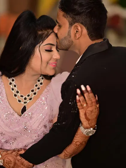 A close-up capturing the joy of their engagement. The bride's delicate jewelry and beautiful pink gown create a soft and romantic look.