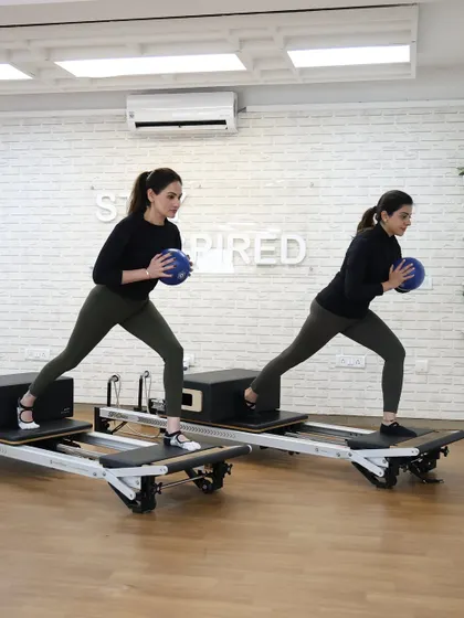 Various shots of members and instructors in action during our dynamic Reformer Pilates classes.
