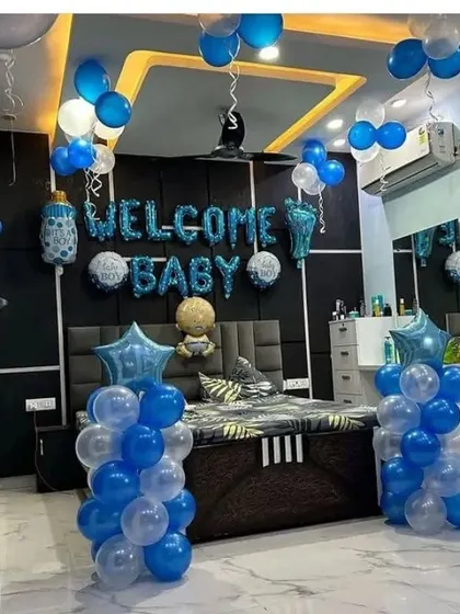 A 'Welcome Baby' bedroom decoration for a baby boy, with blue and white balloons and foil letters.