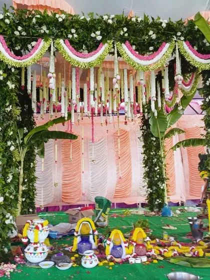 A traditional mandap setup with colorful ritual pots, ready for the wedding ceremony.