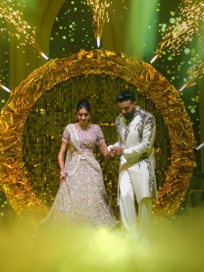 The couple's entrance should be nothing short of spectacular. I designed this shimmering golden halo with integrated pyrotechnics and a soft fog effect to make them feel like they are walking on clouds as they enter their Sangeet.
