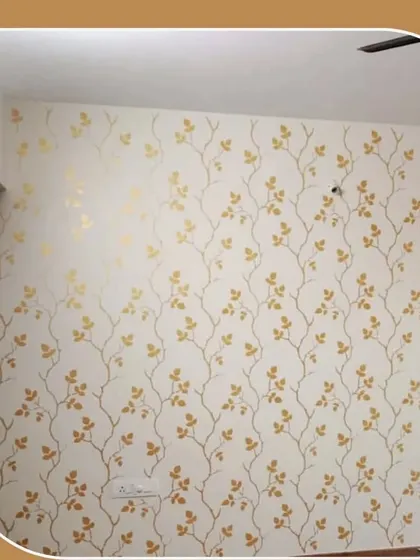 An elegant and delicate wall design featuring golden vines and leaves on a white background, adding a touch of nature-inspired sophistication.
