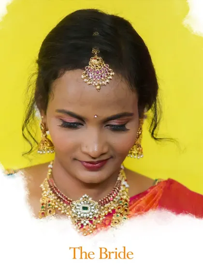A classic bridal portrait taken in my studio. The bright yellow background contrasts beautifully with the bride's red saree and traditional temple jewelry, creating a vibrant and celebratory image.