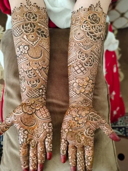 The final look of a beautiful bridal hands design. The pattern is a mix of traditional Indian and floral elements, with careful attention to symmetry and detail.