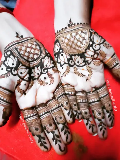 A fancy, modern design for the back of the hands. The pattern uses negative space to create a bold look, with lotus and grid motifs.
