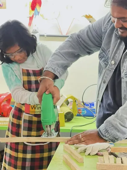 With an apron and safety goggles on, this young maker learns how to use a jigsaw with help from our instructor. We empower kids to use real tools safely.