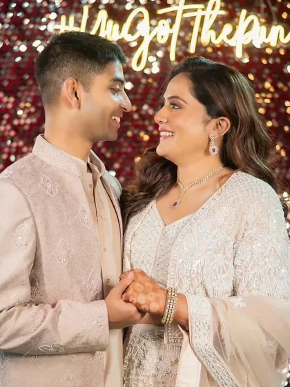 A romantic shot of the couple at their sangeet. Her makeup is soft and pretty, with a focus on her beautiful smile.