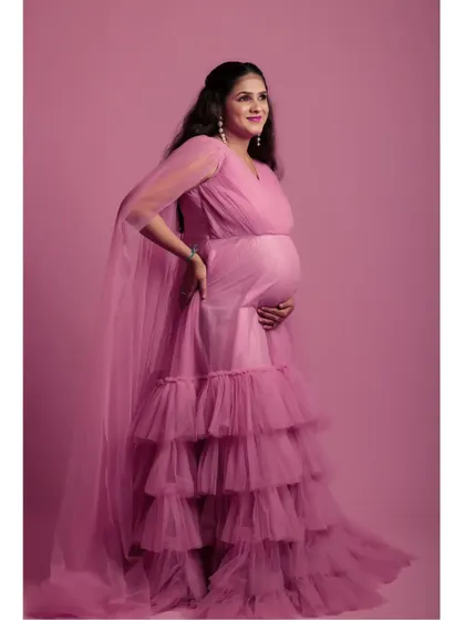 The full view of the pink tiered ruffle gown shows its beautiful layers. This dress is available for rent for your shoot, and you can book my in-house studio for a complete, hassle-free experience.