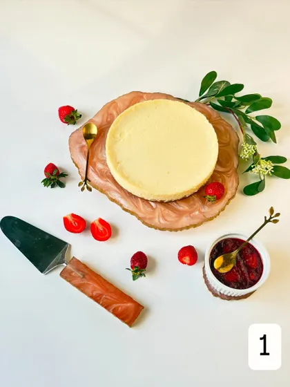This is my bestseller, the Baked Yogurt Cheesecake, styled with fresh strawberries and our homemade compote. It's lighter than a traditional cheesecake but every bit as delicious and creamy.