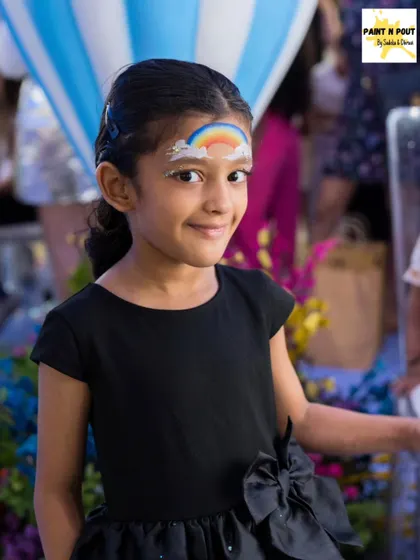 A simple yet beautiful rainbow painted on a child's forehead. It's a quick, sweet design that always gets a happy smile.