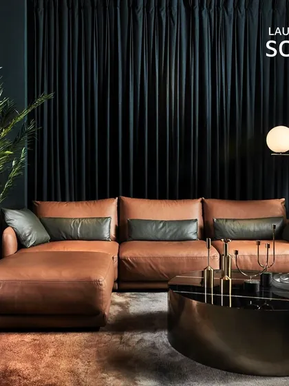 The Laurent Sofa in rich, warm brown leather. This piece exudes timeless sophistication, with its plush cushions and classic L-shape design, making it a luxurious and inviting centerpiece for any living room.