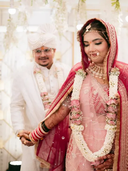 The couple taking their first steps together after the ceremony, hand in hand.