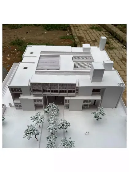 An aerial view of the physical model for the Brilliant National School. This allows us to study the overall massing of the project and its relationship to the surrounding site, including landscaping and access points.
