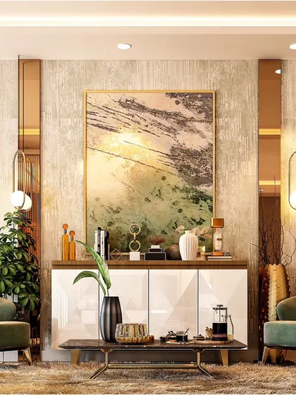 A cozy seating nook in a larger living area, featuring two comfortable green armchairs. The combination of wood-paneled walls and abstract art creates a perfect corner for conversation or reading.