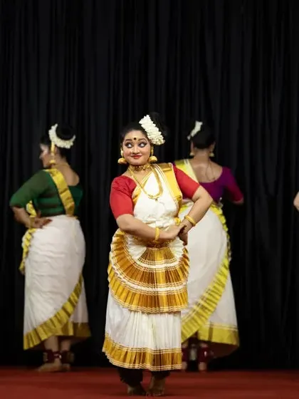 A lead dancer takes center stage, surrounded by the ensemble, demonstrating the blend of solo and group work within our full-length shows.
