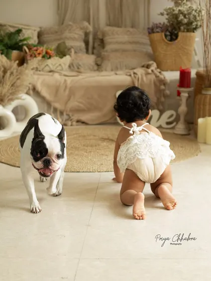 The sweetest duo you'll ever meet! A baby and her playful pup, crawling side-by-side. Capturing their friendship as they grow up together is truly special.