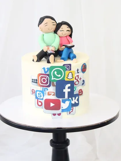 A fun cake for a dad and daughter who share a birthday and a love for their phones. The cake is decorated with a collage of social media app icons and topped with custom fondant figures of the duo.