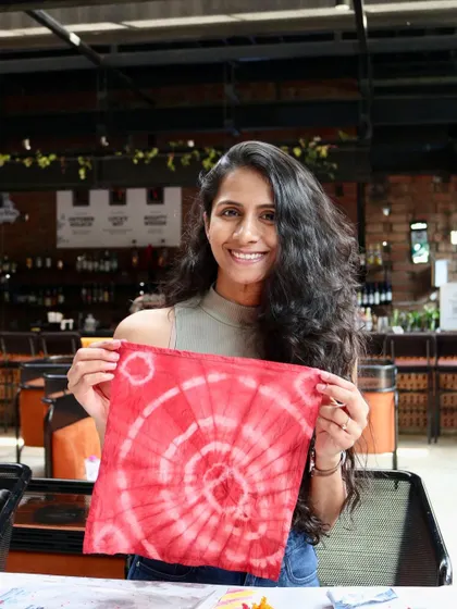 A stunning circular pattern on a red napkin, created at our 'Sundye' party. It's always a joy to see the beautiful and unique designs that emerge from the dye bath.