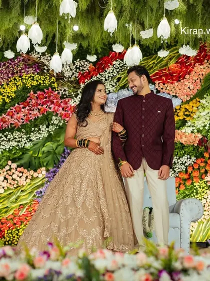 A full view of the artistic, multi-colored flower wall, showing how it creates a stunning and unique focal point for the reception.