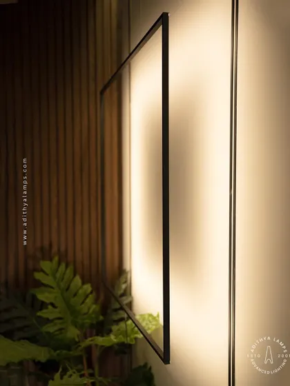 This unique floor-to-ceiling fixture features a large, suspended square frame that washes the wall with a soft, ambient light. It acts as both a light source and a bold, graphic art piece for a contemporary living room.
