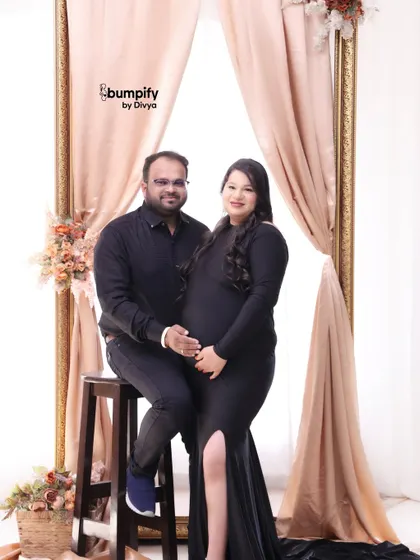 A lovely portrait of the couple in our studio. The soft, elegant drapes in the background add a touch of class to this black dress maternity session.