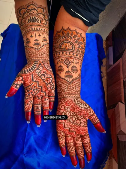 The beautiful red stain of this bridal henna is just starting to develop. The design features traditional jhumka and lotus motifs for a classic look.