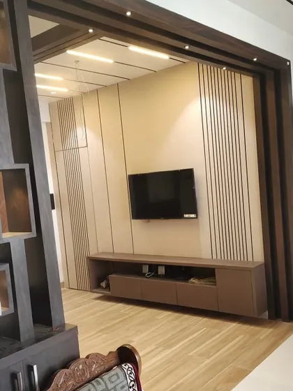 Another perspective of the work-in-progress living room, showing how the wooden partition frames the view of the entertainment area.