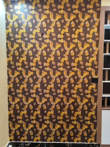 A dark wallpaper with a repeating golden leaf pattern, perfect for a sophisticated accent wall.