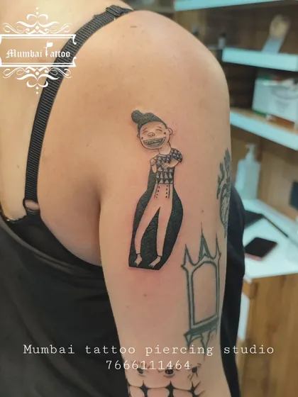 A unique tarot card tattoo on the upper arm. We enjoy bringing mystical and symbolic art to life, ensuring each detail from the original card is captured.