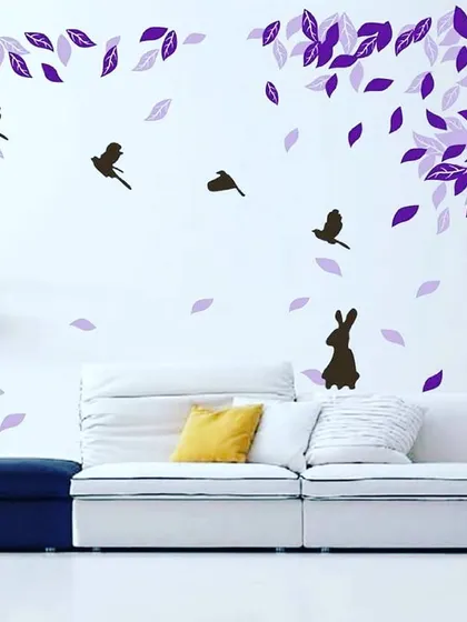 A whimsical living room mural with purple leaves, birds, and a rabbit silhouette. This is an example of a simple yet effective way to add personality to a main living area.